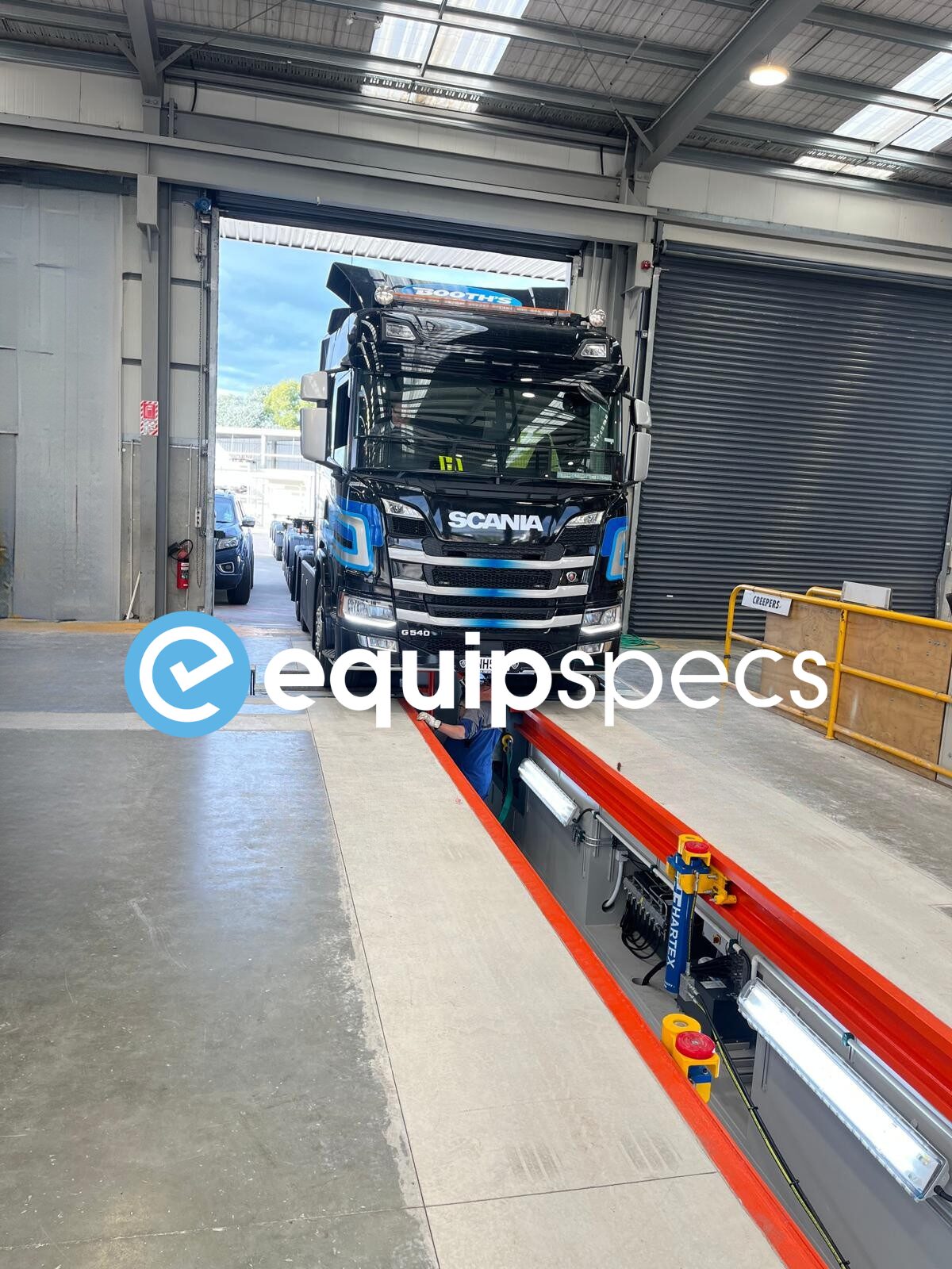 Truck driving over a Prefabricated Steel Inspection Pit installed by EquipSpecs