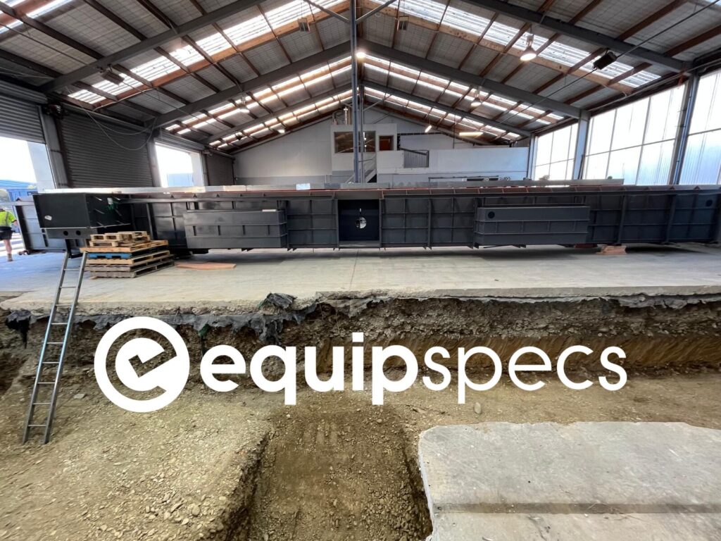 Prefabricated Steel Inspection Pit being lowered into the ground as part of an installation by EquipSpecs.