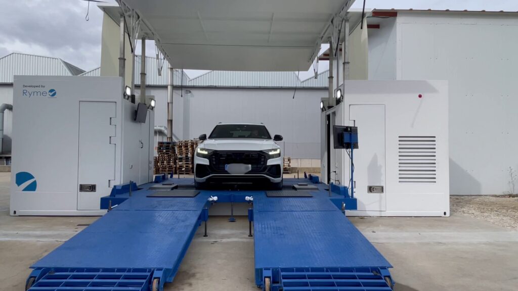 Car driving through the Ryme Worldwide Universal Mobile Container. 