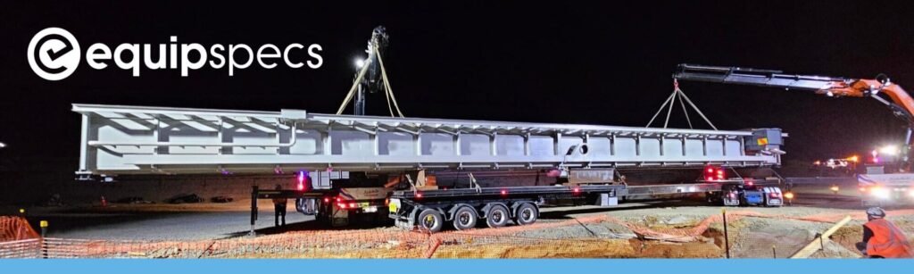 A picture of a crane at night lifting up an EquipSpecs NZ prefabricated steel inspection pit ready for placement.