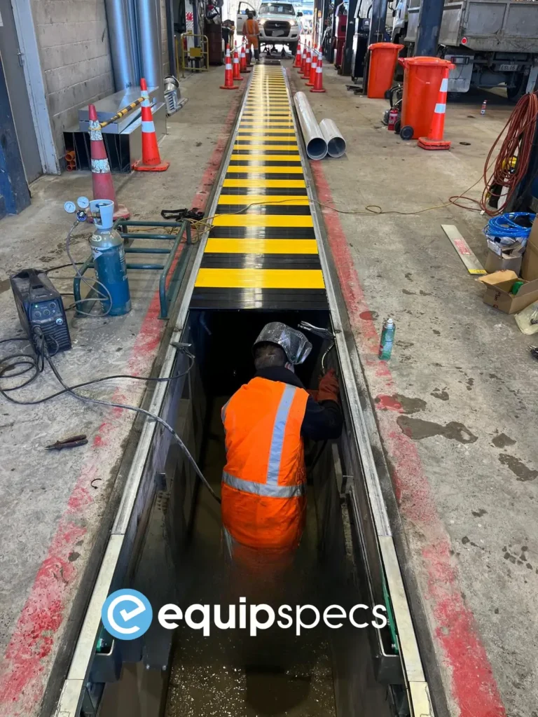 EquipSpecs technician working on an air operated, automatic pit cover. 