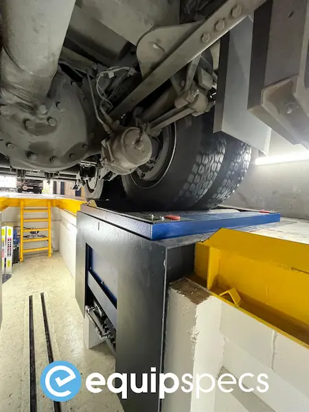 This image shows a close-up of the underside of a truck with a Ryme Worldwide FRU-4 truck brake tester and subframe visible.