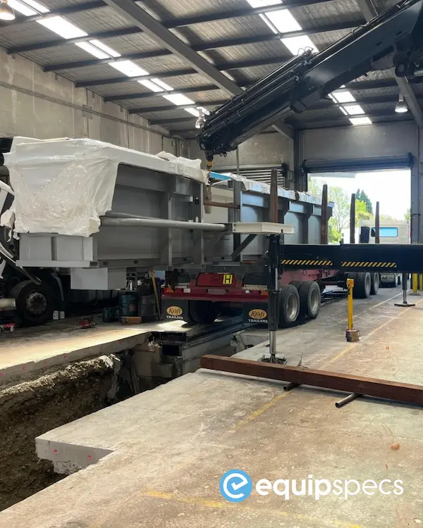 Craning the prefabricated steel pit extension into position during installation.