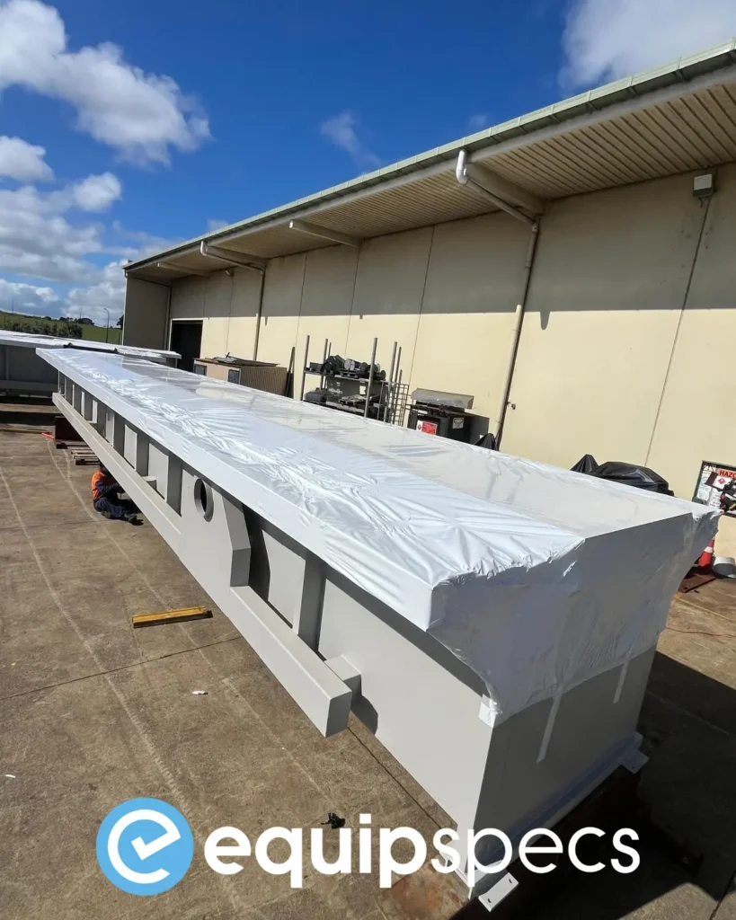 Prefabricated steel inspection pits aligned for quality control at EquipSpecs’ New Zealand facility, ensuring precision engineering and seismic-rated construction.