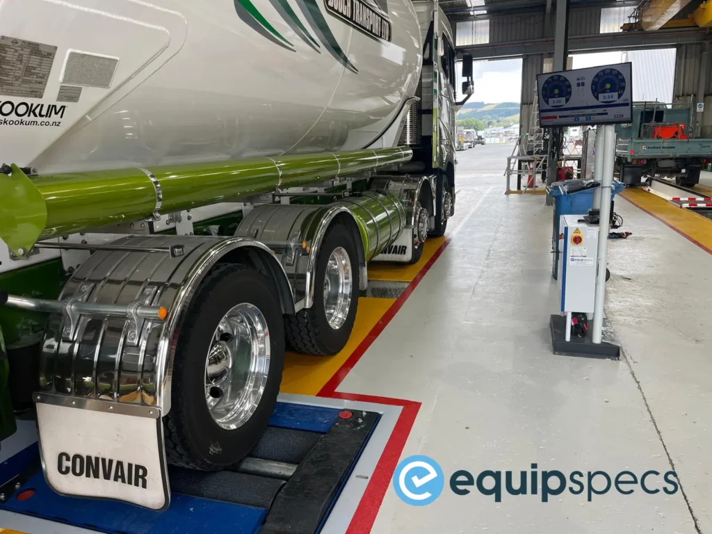 Heavy vehicle axle positioned on Ryme Worldwide FRU 4 roller brake tester within a COF inspection lane.