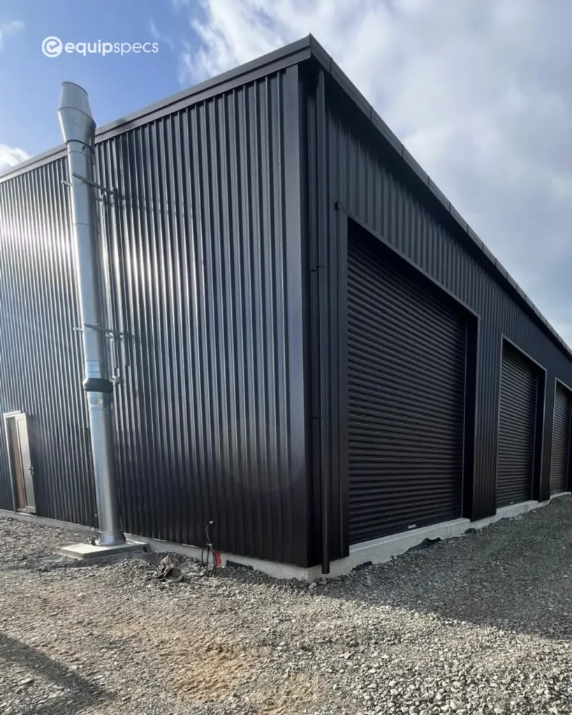 External heavy vehicle workshop ventilation stack installed by EquipSpecs beside a modern industrial workshop building, designed for controlled inspection pit airflow and AS/NZ 60079-aligned ventilation performance.