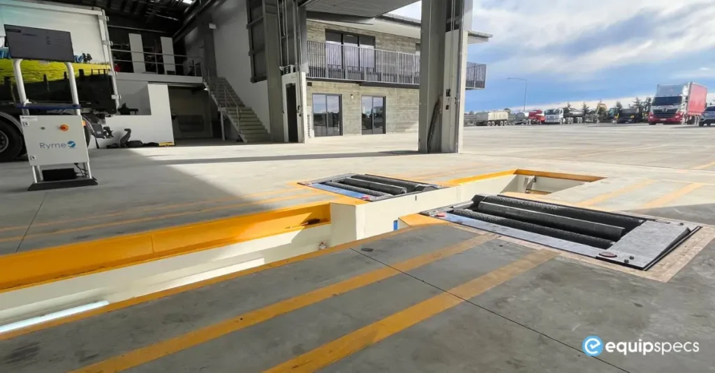 Ryme Worldwide FRU 4 truck roller brake tester installed in a modern heavy vehicle workshop with integrated inspection lane design.