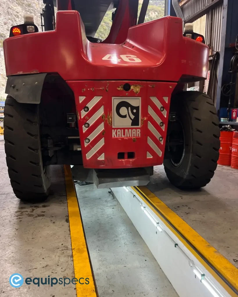 Kalmar heavy equipment vehicle positioned over an inspection pit fitted with LED lighting in a New Zealand workshop.